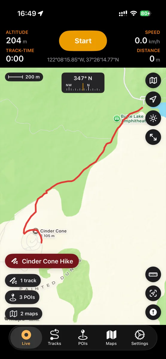 NomadTracks live map on iPhone showing a recorded hiking track to the Cinder Cone summit with compass, scale bar and live recording stats